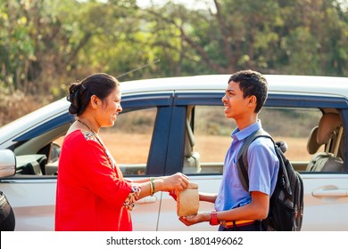 Indian Family Driving Boys To School In Front Of House Gates