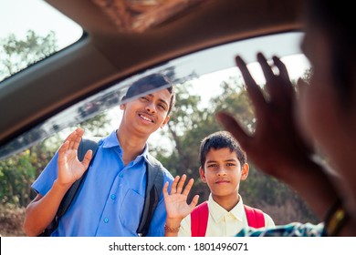 Indian Family Driving Boys To School In Front Of House Gates