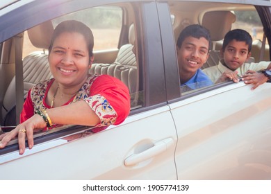 Indian Family Driving Boys To School In Front Of House Gates