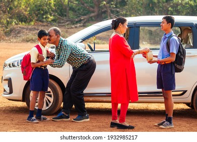 Indian Family Driving Boys To School In Front Of House Gates