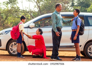 Indian Family Driving Boys To School In Front Of House Gates