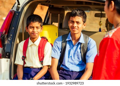 Indian Family Driving Boys To School In Front Of House Gates