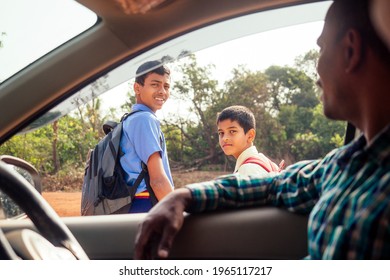 Indian Family Driving Boys To School In Front Of House Gates