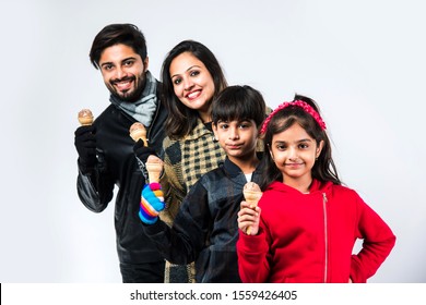 Indian Family Eating Ice Cream In Warm Clothes On White Background