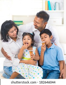 Indian Family Enjoying Eating Ice Cream Indoor