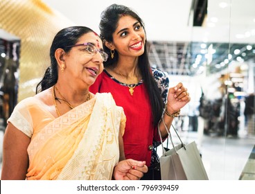 Indian Family Enjoying A Shopping Mall