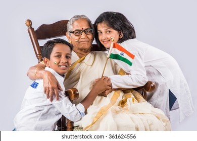 indian family & indian flag, indian family celebrating republican day, independence day and indian flag, old indian woman sitting on chair with grand childrens, 2 small girls with grandmother & flag 