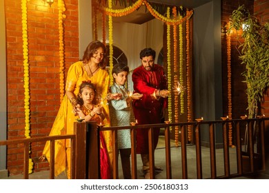 Indian family of four celebrating Diwali with sparklers, creating festive memories together - Powered by Shutterstock