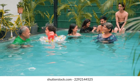 Indian family with inflatable tube in swimming pool enjoying summer vacation. Cheerful girls boys having fun in blue water park with parents. Cute Child relax in colorful toy floating ring at resort  - Powered by Shutterstock