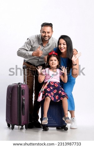 Indian family with luggage on white background