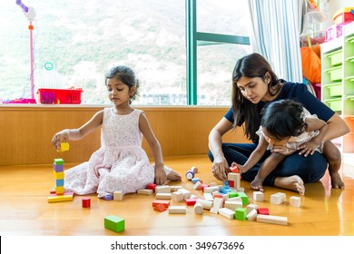 Indian family play toy block together at home