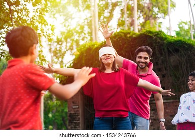 Indian Family Playing Blindfold Game In Park Or Garden, Multi Generation Asian Family Playing Outdoor Fun Games