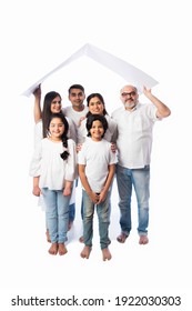 Indian Family And Real Estate Concept - Multigenerational Asian Family Holding Paper House Model With Keys Against White Background