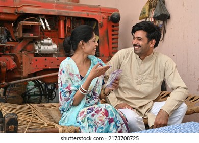 An Indian Family Saving Their Money In Piggy Bank