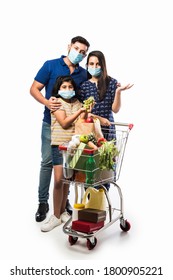 Indian Family Shopping With Kids During Virus Outbreak. Mother, Father And Daughter Wearing Surgical Face Mask Buying Grocery in Supermarket. Family In Shop.