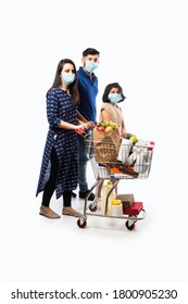 Indian Family Shopping With Kids During Virus Outbreak. Mother, Father And Daughter Wearing Surgical Face Mask Buying Grocery in Supermarket. Family In Shop.