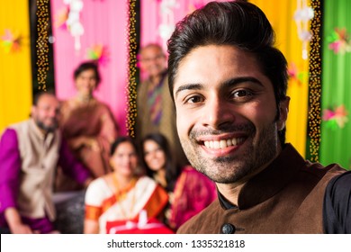 Indian Family Taking Selfie Picture Using Smartphone While Wearing Traditional Festival Cloths On Diwali/wedding Ceremony And Sitting On Sofa / Couch