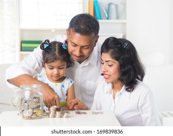 Indian Family Teaching Children On Savings And Financial Planning