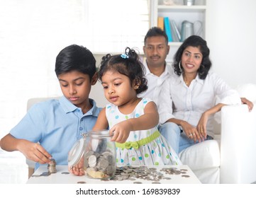 Indian Family Teaching Children On Savings And Financial Planning