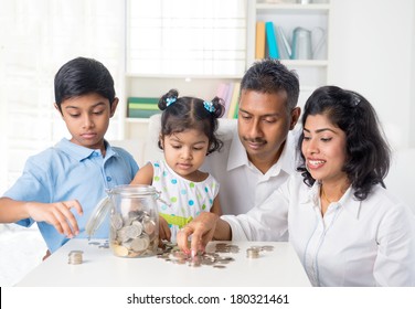 Indian Family Teaching Children On Savings And Financial Planning 