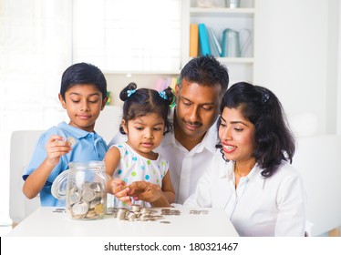 Indian Family Teaching Children On Savings And Financial Planning 