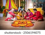 Indian family united in making Diwali flower Rangoli, ganesh festival celebrating bonds, traditions