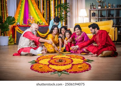 Indian family united in making Diwali flower Rangoli, ganesh festival celebrating bonds, traditions - Powered by Shutterstock