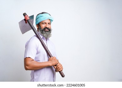 Indian Farmer Holding Farm Equipment In Hand And Giving Expression On White Background.