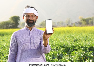 Indian Farmer Showing Mobile Phone In Village