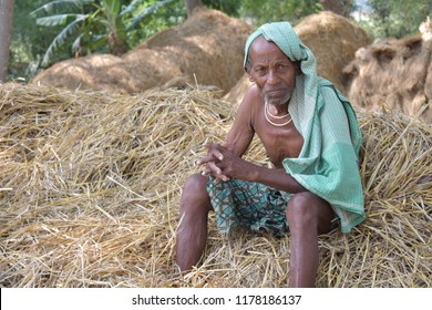 Indian Farmer Sitting In His Field With Sad 