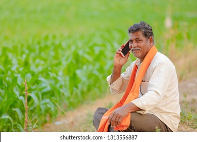 Indian Farmer Using Mobile Phone At Corn Field