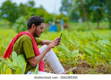 Indian farmer using smartphone at agriculture field - Powered by Shutterstock