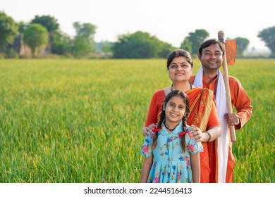 Indian farmer with wife and daughter at agriculture field. - Shutterstock ID 2244516413