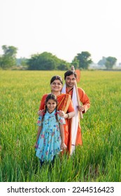 Indian farmer with wife and daughter at agriculture field. - Shutterstock ID 2244516423
