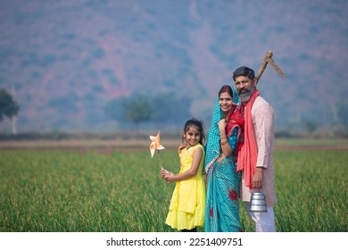 Indian farmer with wife and daughter at agriculture field. - Powered by Shutterstock