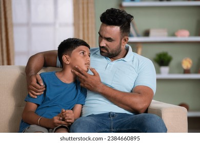 Indian father consoling by giving confidence to son at home - concept of exam failure, family support and conversation - Powered by Shutterstock