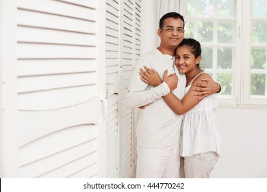 Indian Father And Daughter Hugging And Looking At Camera