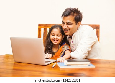 Indian Father And Daughter Using Laptop Computer At Home