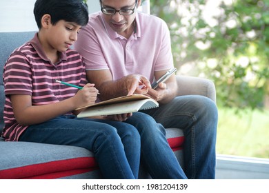 Indian Father Helps Him Check The Accuracy Of His Child's Math Homework, Educate At Home