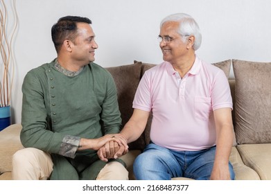 Indian Father And Song Having Conversation At Home 