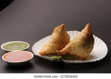 Indian Favourite Snack Samosa Served With Red And Green Chutney
