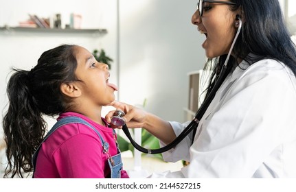 Indian Female Doctor Examining A Cute Little Girl With A Stethoscope - Auscultating Child -