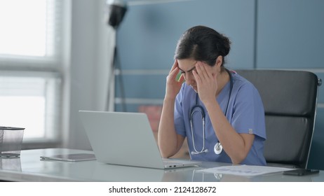 Indian Female Doctor Having Headache While Working On Laptop