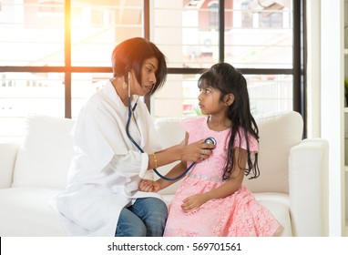 Indian Female Doctor Treating Young Girl Patient