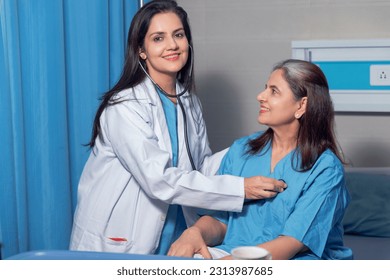 Indian female doctor using a stethoscope for check up on bed at hospital. - Powered by Shutterstock