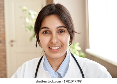 Indian Female Doctor Wear Headset Make Online Video Call Consulting Patient. Call Center Gp Looking At Camera Remote Conference Webcam Chat. Webcam View, Face Headshot. Telemedicine In India.