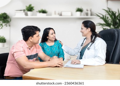 Indian female gynecologist doctor consulting young married couple patients in fertility clinic about IVF or IUI. Planning pregnancy concept. - Powered by Shutterstock