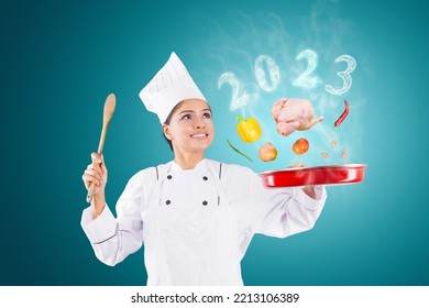 Indian female magician chef cooking on a saucepan with flying food ingredients and smoke shaped of 2023 numbers in the kitchen - Shutterstock ID 2213106389