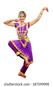 Indian female performing Bharathanatyam doing the action of  depicting Lord Ganesha  in violet color costumes 
