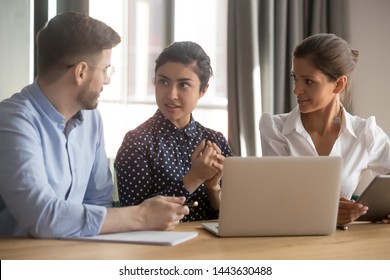 Indian female professional mentor helping interns trainees coworkers explain computer work at workplace, diverse leader and employees discuss online project in office, apprentice mentoring concept - Shutterstock ID 1443630488
